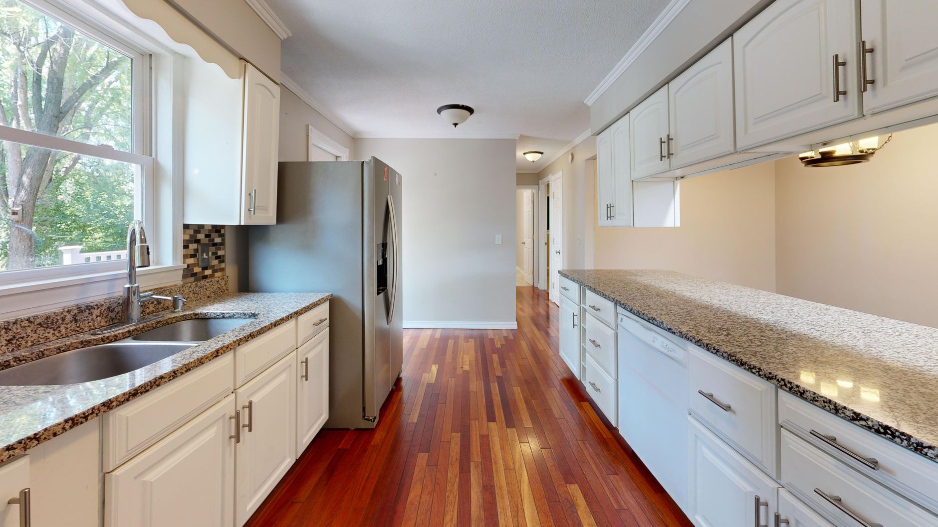 Elegant modern kitchen featuring granite countertops and stainless steel appliances in Bellevue, WA